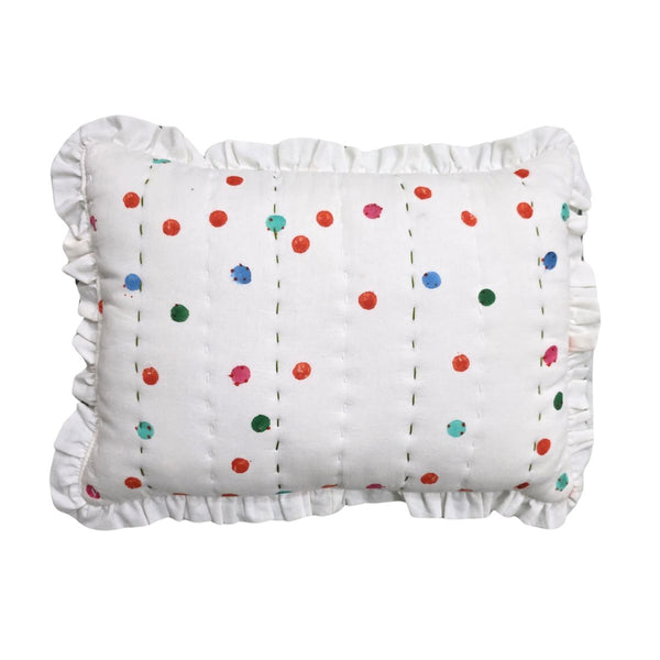 A white ruffled lumbar pillow with vertical dashed stitching and scattered colorful embroidered dots in red, blue, green, and pink, shown against a plain white background.