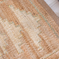 Close-up of a textured beige rug with a subtle pattern