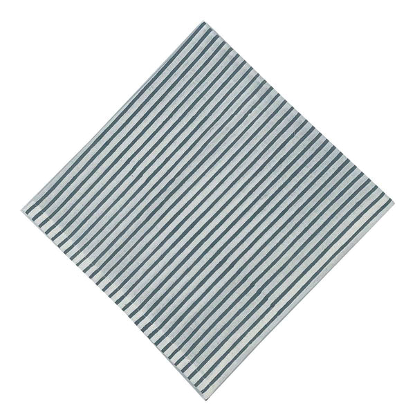 A striped blockprint napkin with French blue color scheme on a white background.