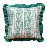 Decorative pillow with green floral pattern and ruffled edge on a white background