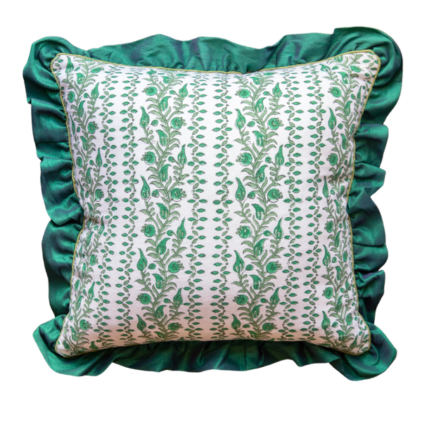 Decorative pillow with green floral pattern and ruffled edge on a white background
