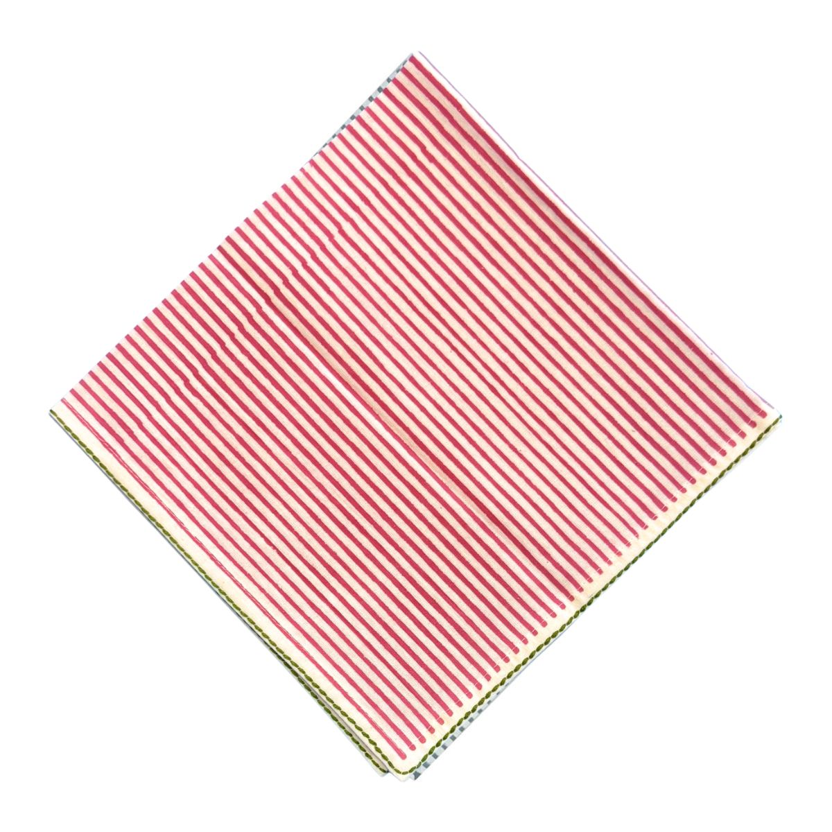 A square fabric napkin with thin hot pink and white vertical stripes, folded diagonally on a plain white background.