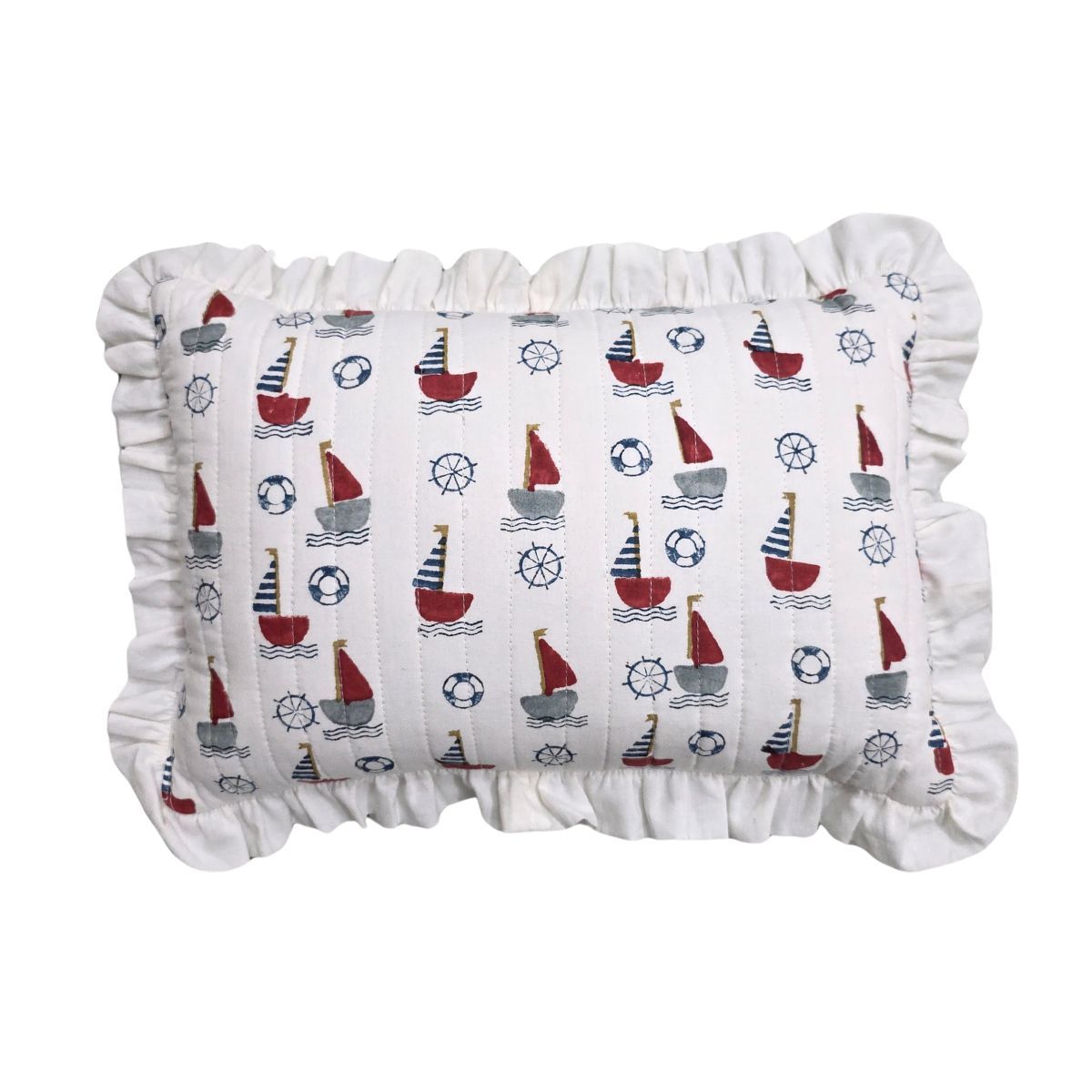 A rectangular ruffled pillow with a white fabric body printed with a nautical sailboat pattern in red, navy, and gray, finished with a ruffled edge.