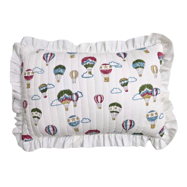 A square white pillow with a ruffled border, featuring an all-over print of colorful hot air balloons and clouds.